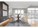 Bright dining room with a glass table, white chairs, and large windows overlooking the yard at 8810 E 200 S, Zionsville, IN 46077