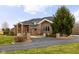 Elegant brick home boasts a circular driveway, manicured landscaping, and charming architectural details at 8810 E 200 S, Zionsville, IN 46077