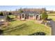 A brick-facade home with a well-manicured lawn and mature landscaping at 8810 E 200 S, Zionsville, IN 46077