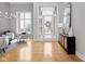 Elegant foyer featuring hardwood floors, a stylish mirror, and a bright, welcoming atmosphere at 8810 E 200 S, Zionsville, IN 46077