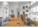 Bright foyer features soaring ceilings, hardwood floors, and staircase with decorative insets and wrought iron spindles at 8810 E 200 S, Zionsville, IN 46077