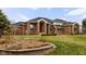 Beautiful brick home with a manicured lawn, mature trees, and thoughtfully designed landscaping at 8810 E 200 S, Zionsville, IN 46077
