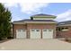 Spacious three-car garage with white doors and a concrete driveway, perfect for car enthusiasts or extra storage at 8810 E 200 S, Zionsville, IN 46077