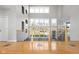 Bright hallway with hardwood floors, a staircase with metal railings, and natural light from large windows at 8810 E 200 S, Zionsville, IN 46077