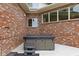 Private outdoor hot tub area featuring a modern hot tub with steps and a brick surround for relaxation at 8810 E 200 S, Zionsville, IN 46077