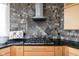 Stylish kitchen with a gas cooktop, mosaic tile backsplash, and natural wood cabinets at 8810 E 200 S, Zionsville, IN 46077