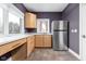 Cozy kitchenette with stainless steel appliances and ample counter space, complemented by wood cabinets at 8810 E 200 S, Zionsville, IN 46077