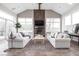 Comfortable living room with a stone fireplace, vaulted ceilings, and large windows at 8810 E 200 S, Zionsville, IN 46077