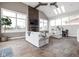 Spacious living room with a stone fireplace, vaulted ceilings, and large windows at 8810 E 200 S, Zionsville, IN 46077