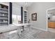 Office with built-in shelving, large window with blue drapes, and a white desk at 8810 E 200 S, Zionsville, IN 46077