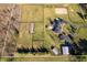 Overhead view of a luxurious estate with a spacious home, paddocks, and manicured lawns, bordered by mature trees at 8810 E 200 S, Zionsville, IN 46077
