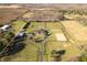 Aerial view of a magnificent property with a large home, equestrian areas, and a long private driveway at 8810 E 200 S, Zionsville, IN 46077
