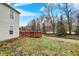 The backyard has a charming deck, perfect for outdoor relaxation, and a lush lawn, surrounded by mature trees at 10270 Yosemite Ln, Indianapolis, IN 46234