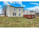 The house's exterior backyard view features a well-maintained lawn, wooden deck, and the side view of neighboring houses at 10270 Yosemite Ln, Indianapolis, IN 46234