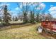 A cozy wooden deck and spacious backyard with lush greenery and mature trees offer a serene outdoor retreat at 10270 Yosemite Ln, Indianapolis, IN 46234