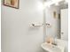 Simple powder room features a pedestal sink, framed mirror and neutral walls for a clean and fresh feel at 10270 Yosemite Ln, Indianapolis, IN 46234