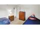 This is a simply furnished bedroom with a nightstand and lamp, a dresser and a bed at 10270 Yosemite Ln, Indianapolis, IN 46234