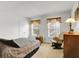 This bedroom has carpeted flooring, two windows, a bed and a chair at 10270 Yosemite Ln, Indianapolis, IN 46234