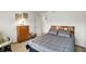 This carpeted bedroom has a queen sized bed, a nightstand and a wooden dresser at 10270 Yosemite Ln, Indianapolis, IN 46234