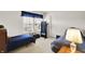 This bedroom has neutral carpeting, 2 twin beds, a window, and a door to the right at 10270 Yosemite Ln, Indianapolis, IN 46234