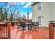 This back deck is made of wood and has a table and chairs with an umbrella at 10270 Yosemite Ln, Indianapolis, IN 46234