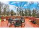 This wood deck has a table, 6 chairs, an umbrella and a propane tank at 10270 Yosemite Ln, Indianapolis, IN 46234