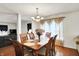 Well-lit dining area with wooden table, chandelier, and view of the living room at 10270 Yosemite Ln, Indianapolis, IN 46234
