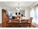 Bright dining room with a chandelier, wooden table, and large window at 10270 Yosemite Ln, Indianapolis, IN 46234