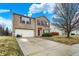 Charming two-story brick home with a spacious driveway and well-maintained lawn on a beautiful day at 10270 Yosemite Ln, Indianapolis, IN 46234