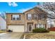Charming brick two-story home featuring a two-car garage, complemented by well-maintained landscaping and lovely yard at 10270 Yosemite Ln, Indianapolis, IN 46234