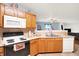 Cozy kitchen with wood cabinets, microwave, and stove at 10270 Yosemite Ln, Indianapolis, IN 46234