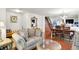 Inviting living room features a cozy sofa, elegant mirror, and seamless transition to the dining area at 10270 Yosemite Ln, Indianapolis, IN 46234