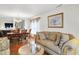 Open-concept living room with hardwood floors, seamlessly connected to a dining area creating a versatile living space at 10270 Yosemite Ln, Indianapolis, IN 46234
