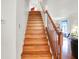 Staircase featuring wood steps, neutral walls and banister leading up to an open living space at 10270 Yosemite Ln, Indianapolis, IN 46234