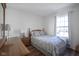 Bedroom features a comfy bed, wood floors, and a bright window at 10920 Gate Cir, Fishers, IN 46038