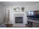 Cozy fireplace with white-painted brick and decorative mantel at 10920 Gate Cir, Fishers, IN 46038