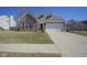 Charming brick home with a well-maintained lawn, dormer windows, and an attached two-car garage at 10920 Gate Cir, Fishers, IN 46038