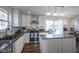 Stylish kitchen with granite countertops, stainless steel appliances, and backyard views at 10920 Gate Cir, Fishers, IN 46038