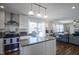 Open kitchen with granite island, stainless appliances, view to living and dining areas at 10920 Gate Cir, Fishers, IN 46038