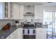 Well-lit kitchen with stainless steel appliances, granite countertops, and white cabinets at 10920 Gate Cir, Fishers, IN 46038