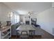Open-concept living room with fireplace, ceiling fan, and gray sofa at 10920 Gate Cir, Fishers, IN 46038