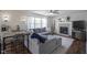 Comfortable living room with a fireplace, ceiling fan, large sofa, and dining area at 10920 Gate Cir, Fishers, IN 46038