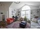 Inviting living room with a large window, vaulted ceiling, bookshelves, and comfortable seating at 10920 Gate Cir, Fishers, IN 46038
