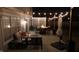 A nighttime view of a patio featuring outdoor furniture, string lights, and a small fire pit at 10920 Gate Cir, Fishers, IN 46038