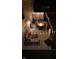 An evening shot of a patio area featuring string lights, outdoor furniture, and a fire pit at 10920 Gate Cir, Fishers, IN 46038
