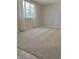 Bright bedroom with a large window, plush carpet and neutral walls at 1103 Charleston Commons Dr, Anderson, IN 46012