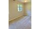 Neutral bedroom with plush carpet, and a bright window with blinds at 1103 Charleston Commons Dr, Anderson, IN 46012