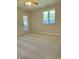 Light-filled bedroom with plush carpet, large window, and access to outdoor area at 1103 Charleston Commons Dr, Anderson, IN 46012