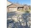 Brick home featuring a two-car garage and a well-maintained lawn at 1103 Charleston Commons Dr, Anderson, IN 46012