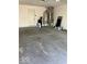 Spacious garage with concrete floors, water heater, and storage space at 1103 Charleston Commons Dr, Anderson, IN 46012